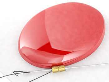 Needle passing through the first two gold beads